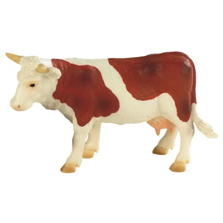 Brown and white cow play figure as a cake topper