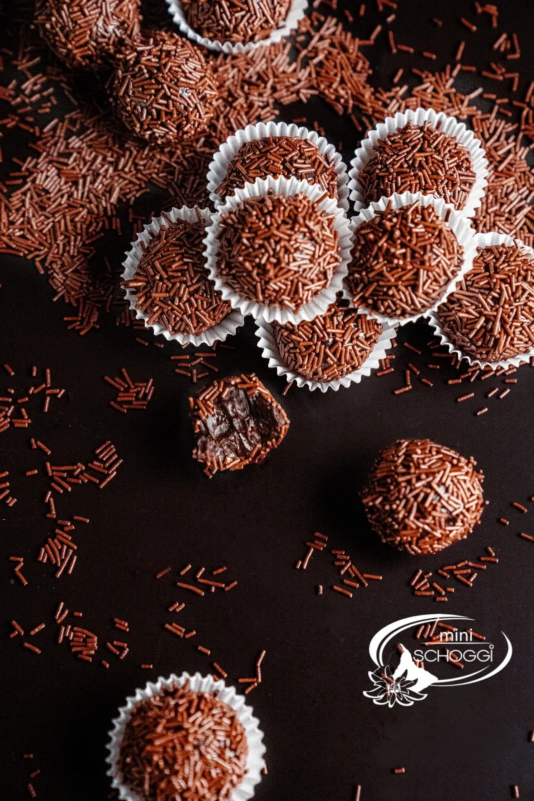 Brigadeiros roulés dans des vermicelles de chocolat, présentés dans des capsules de chocolat blanches