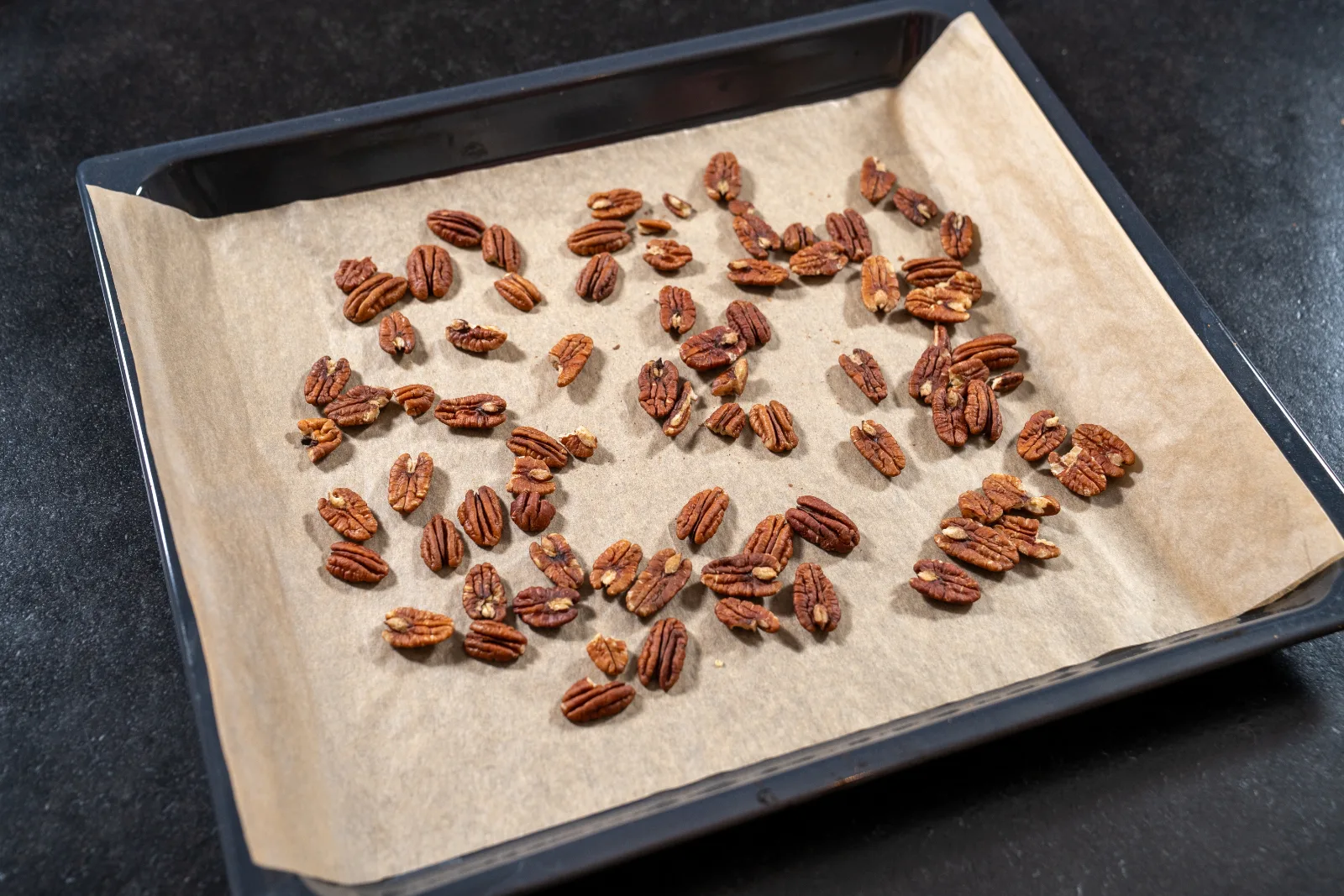 Pecan kernels on the baking tray for roasting