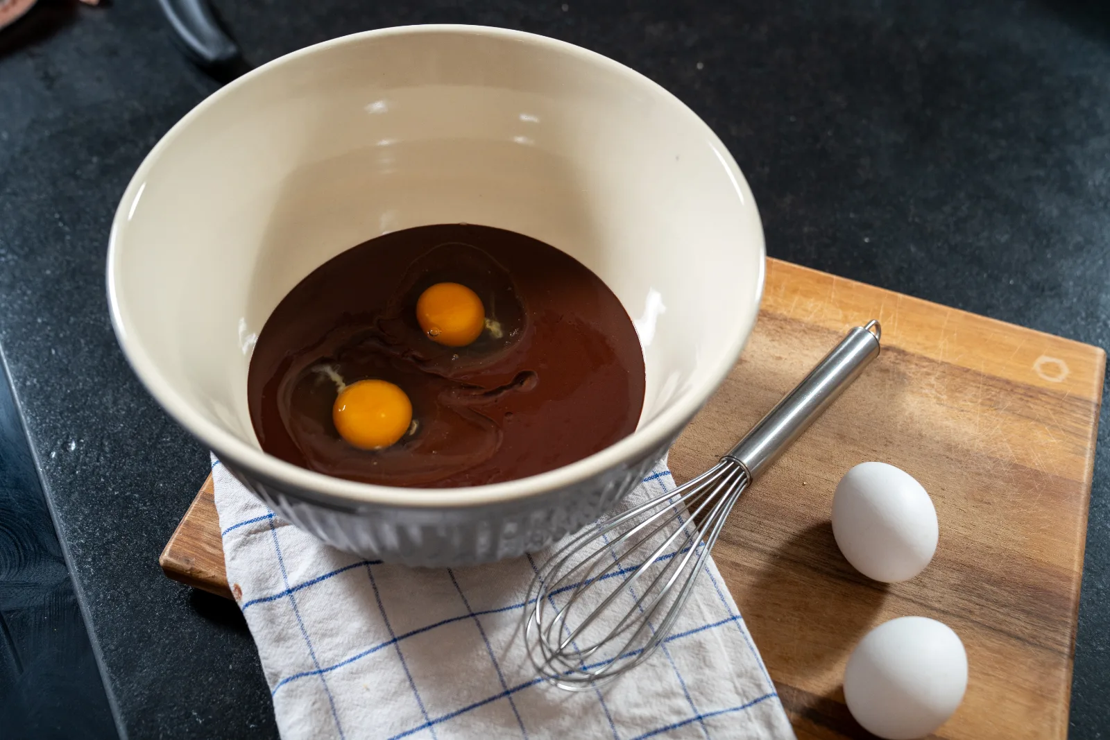 Eggs being stirred gradually into the chocolate mixture
