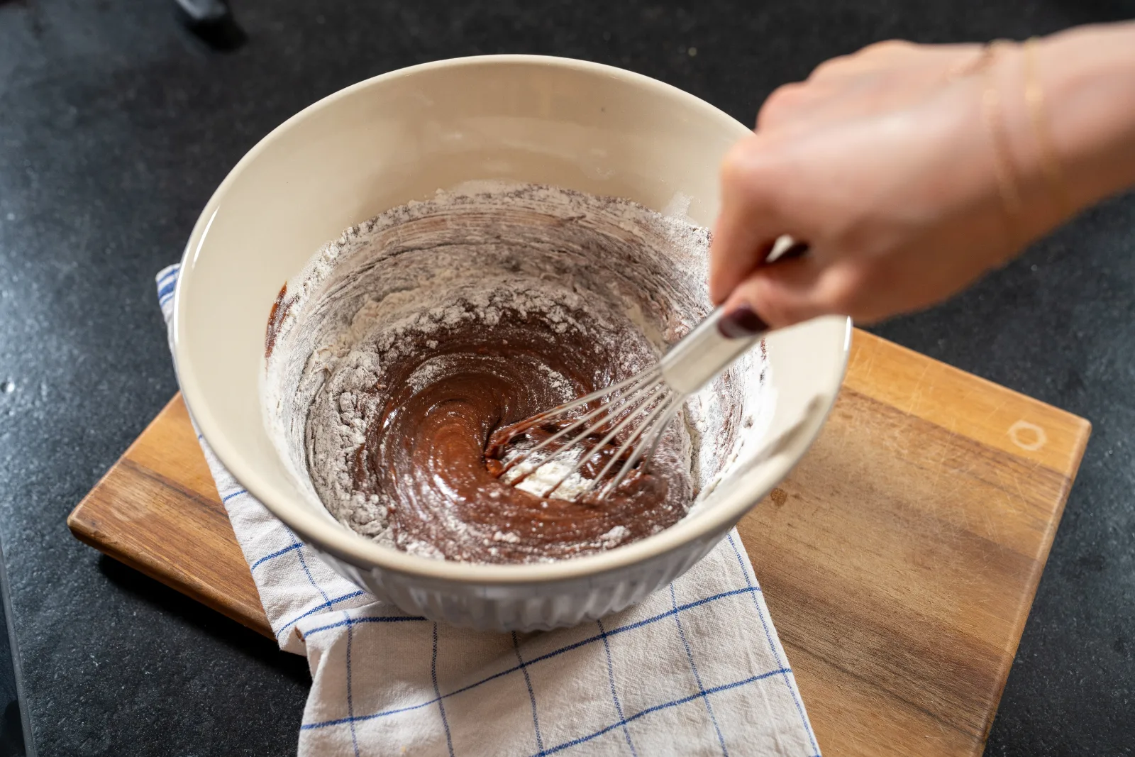 Flour and salt being gently folded into the brownie dough