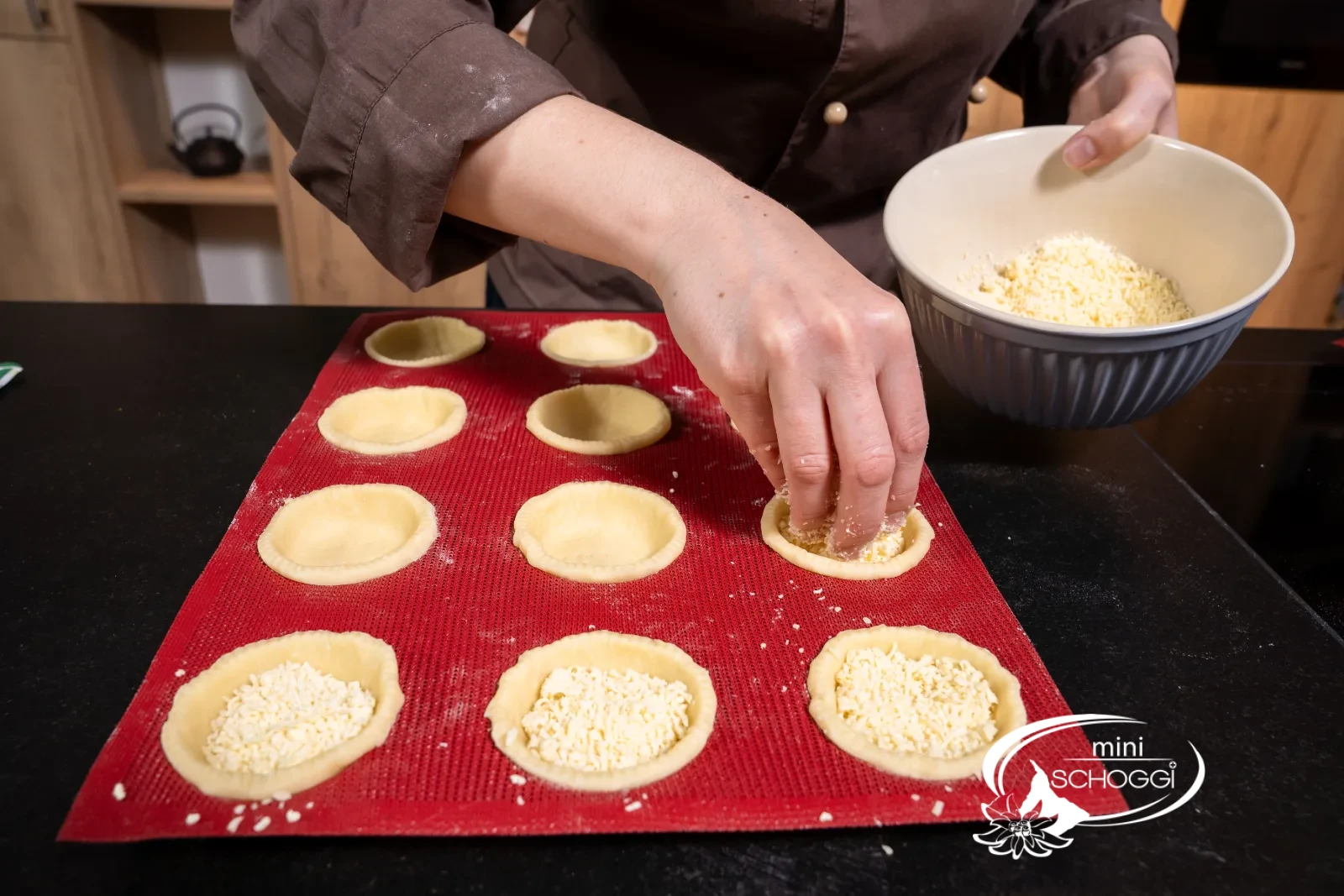 Ogni pasticcino viene riempito con 10 g di gruyère grattugiato