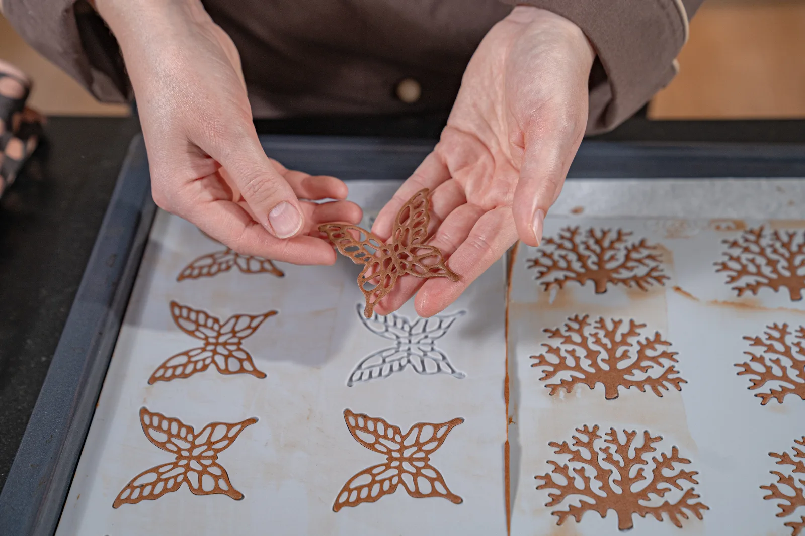 A finished branch motif is carefully released from the Silicone mold