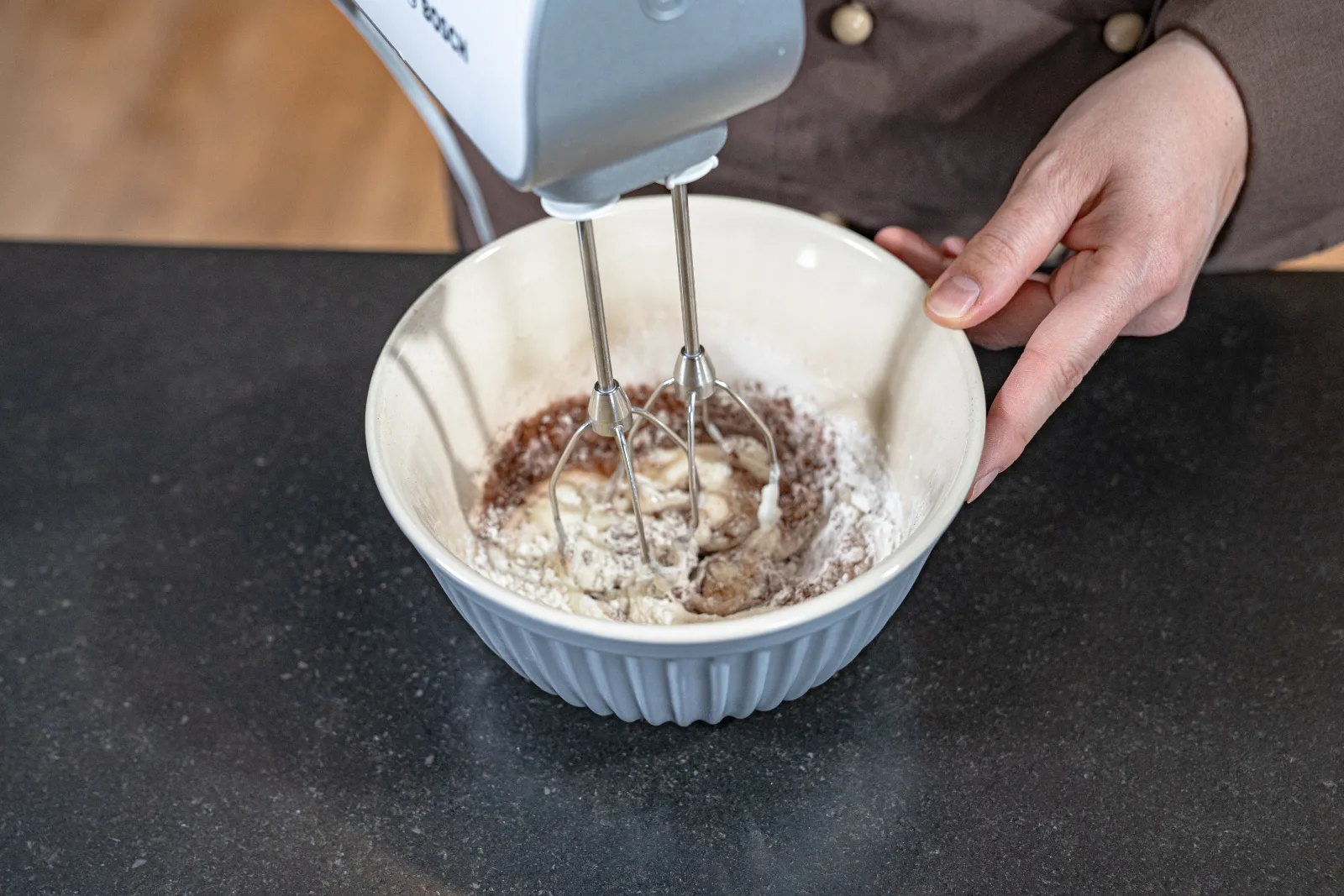 The melted butter is poured onto the foamy egg white