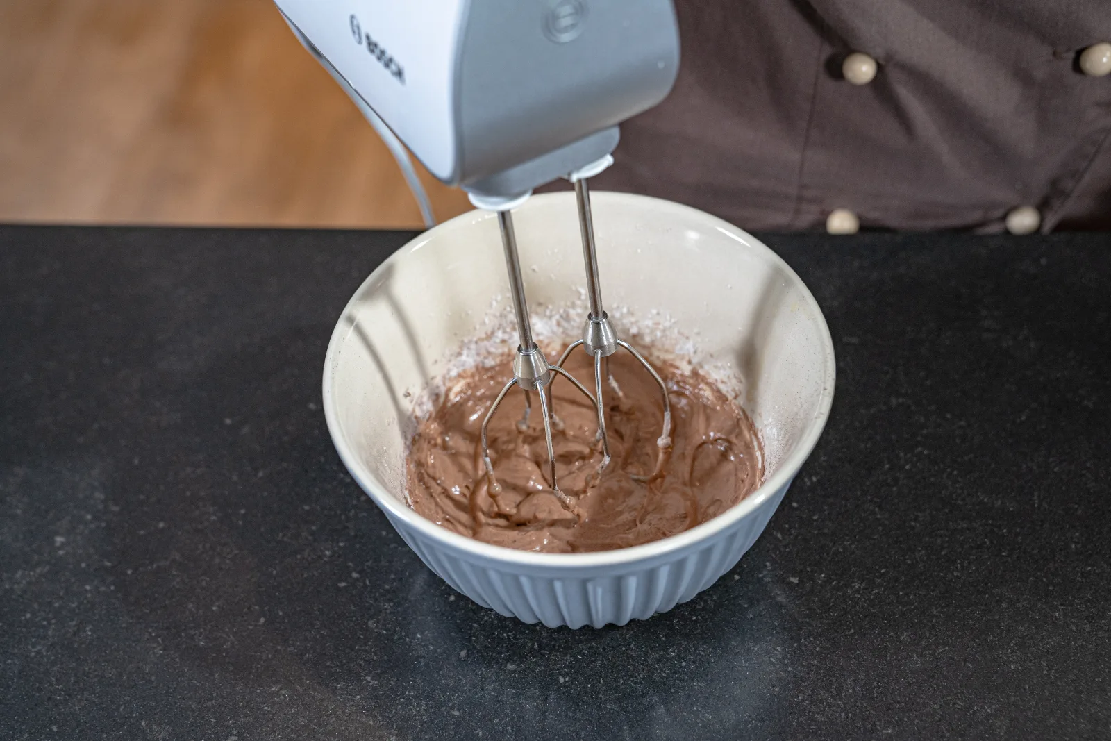Flour and cocoa powder are stirred into the mixture