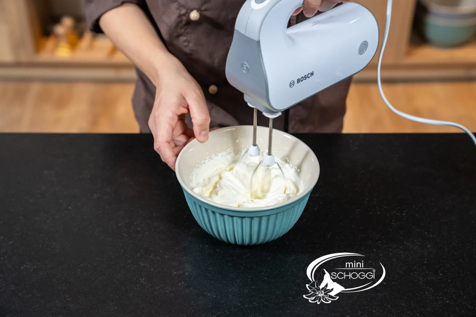 osa Mousse wird mit dem Spritzsack in die Mulden einer Silikonform in Kirschenform gefüllt