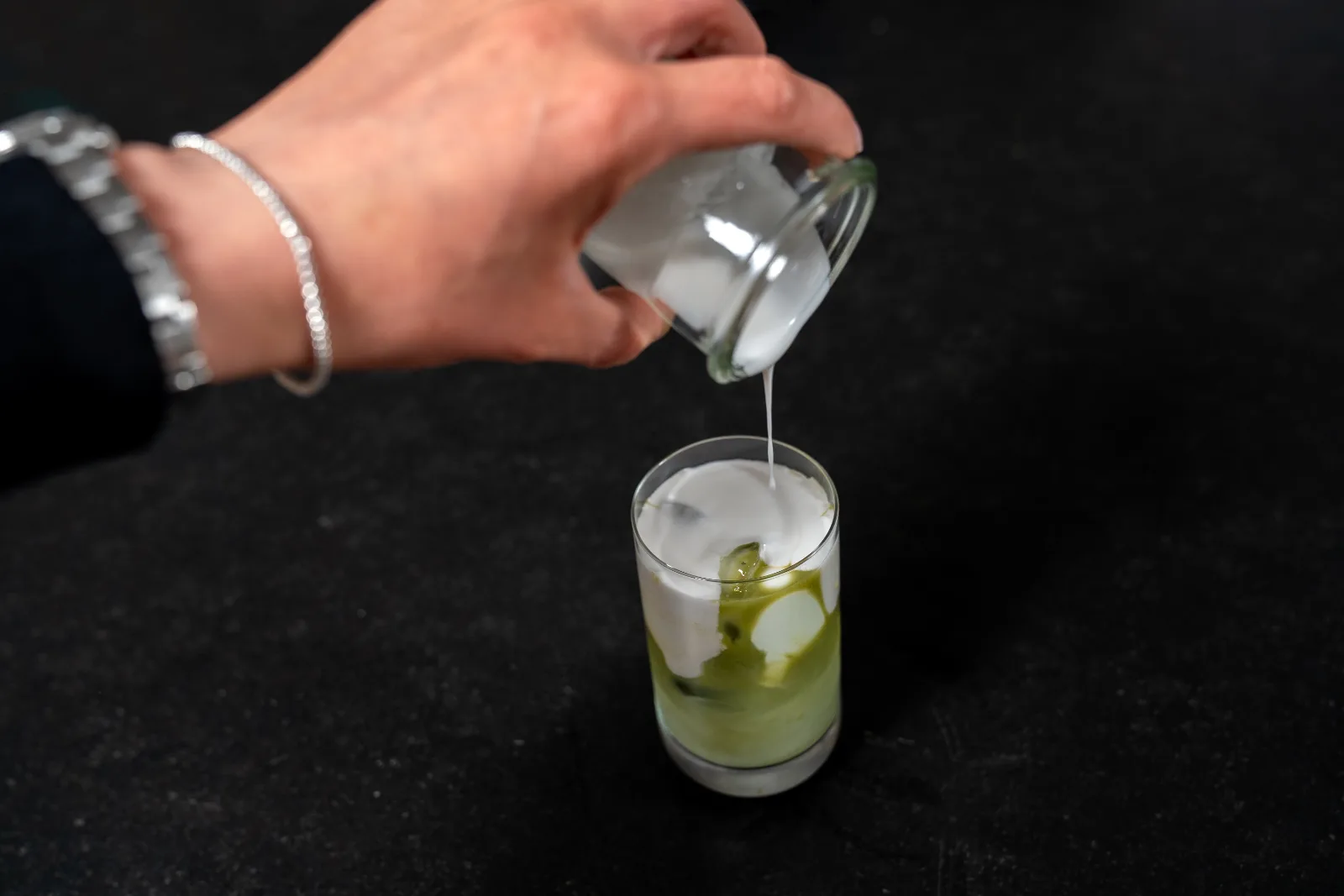Matcha iced latte – mix the coconut milk and pour the matcha over it