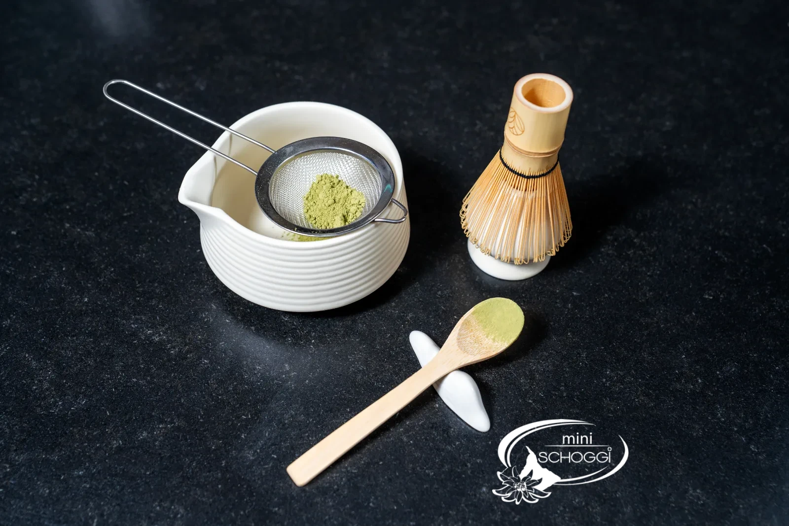 Matcha tin, sieve over the bowl and bamboo whisk ready
