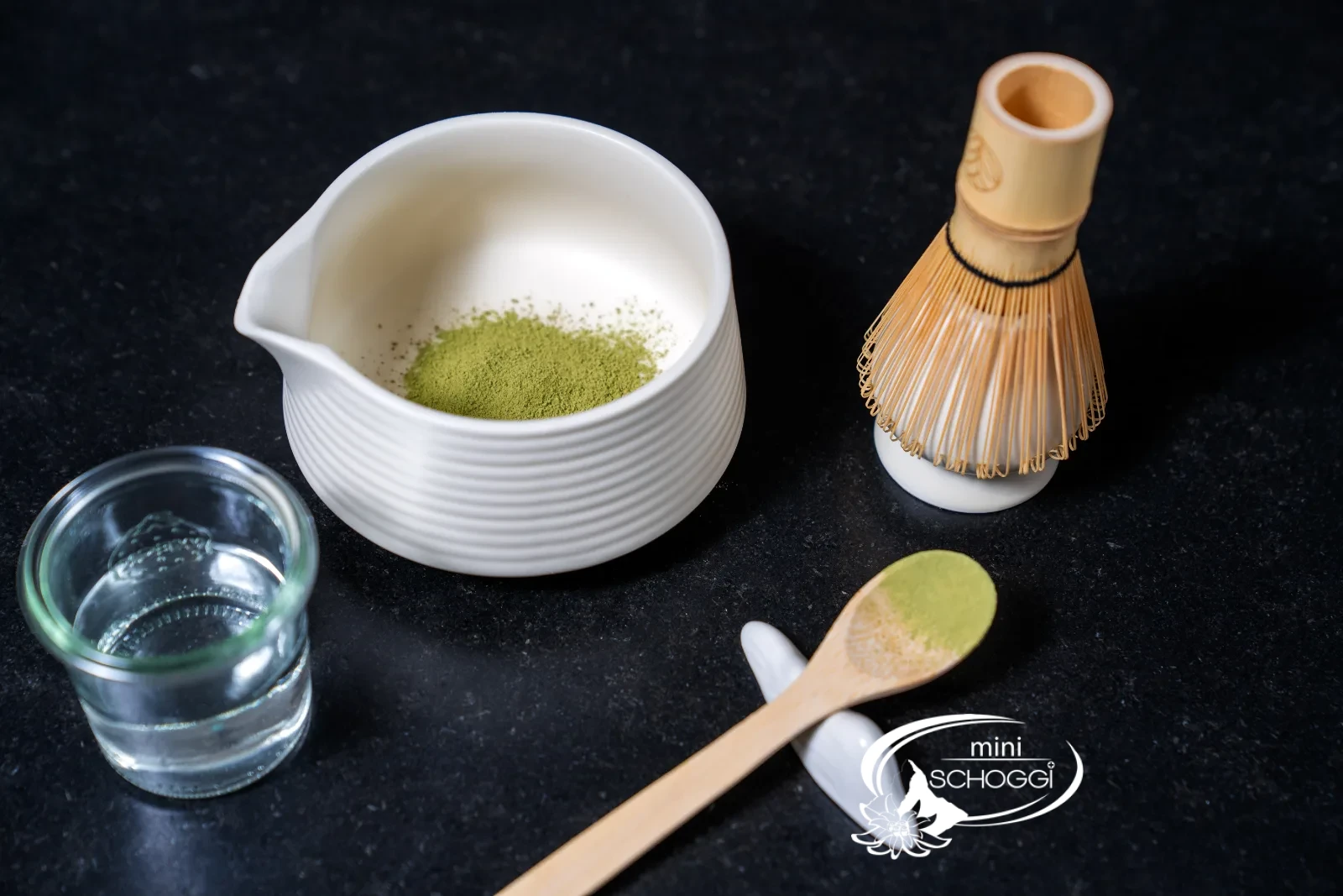 Matcha being pressed through the sieve with a spoon