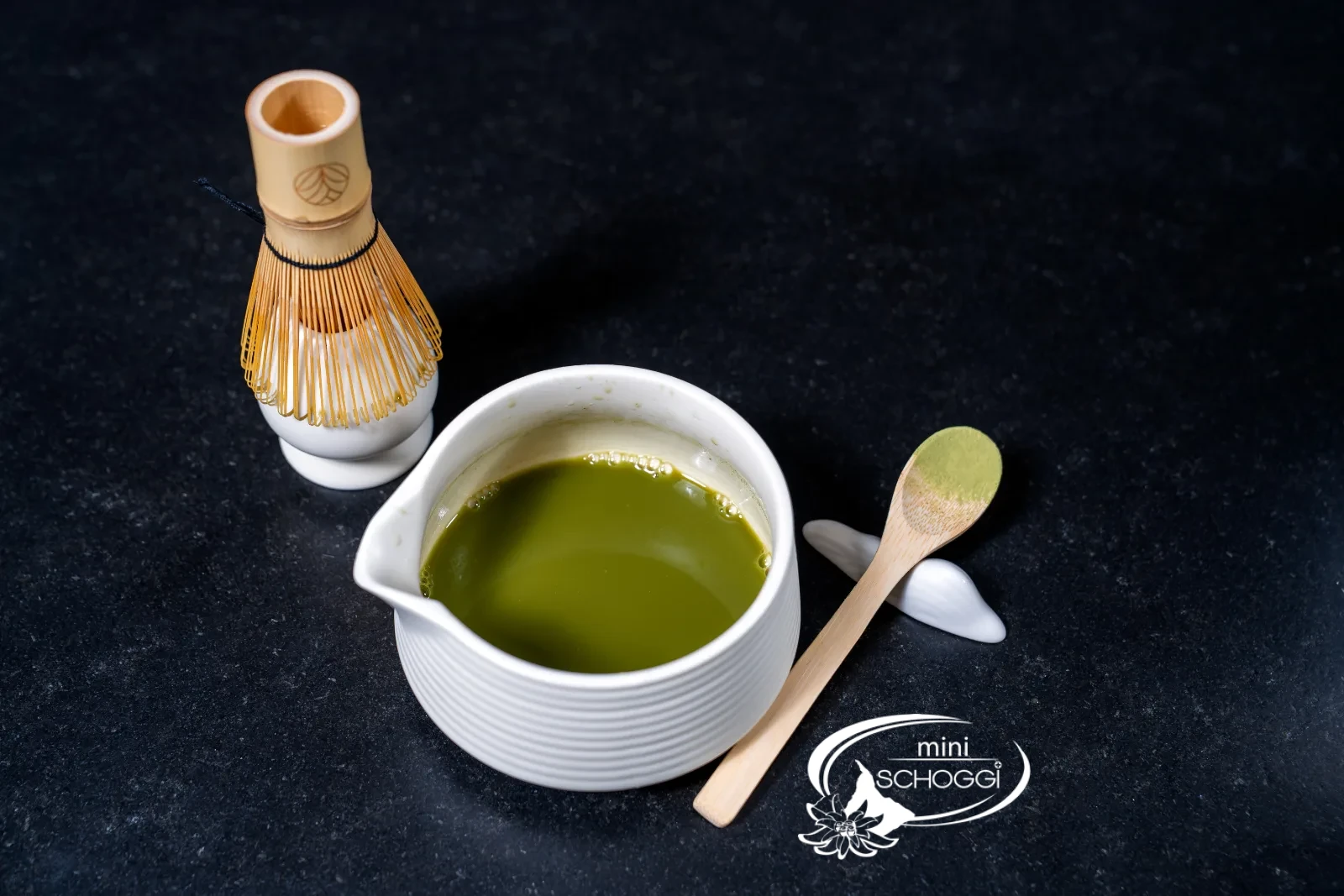 Glasses with ice cubes, a glass of milk and the bowl of matcha ready