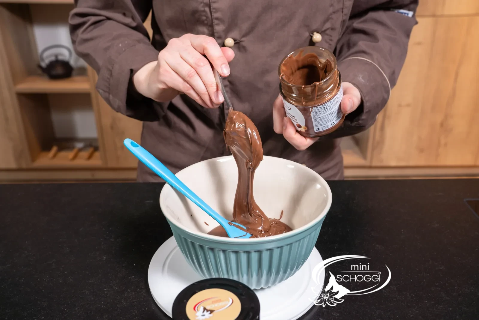 Gianduja Hazelnut cream is added from the jar to the couverture