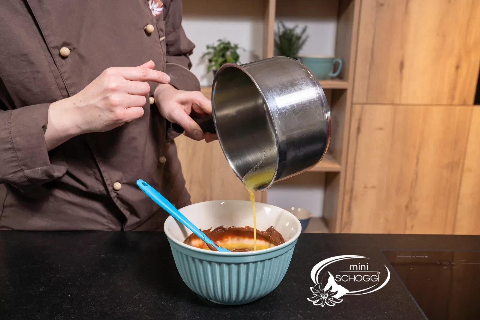 The liquid butter is poured from the pan into the chocolate mixture