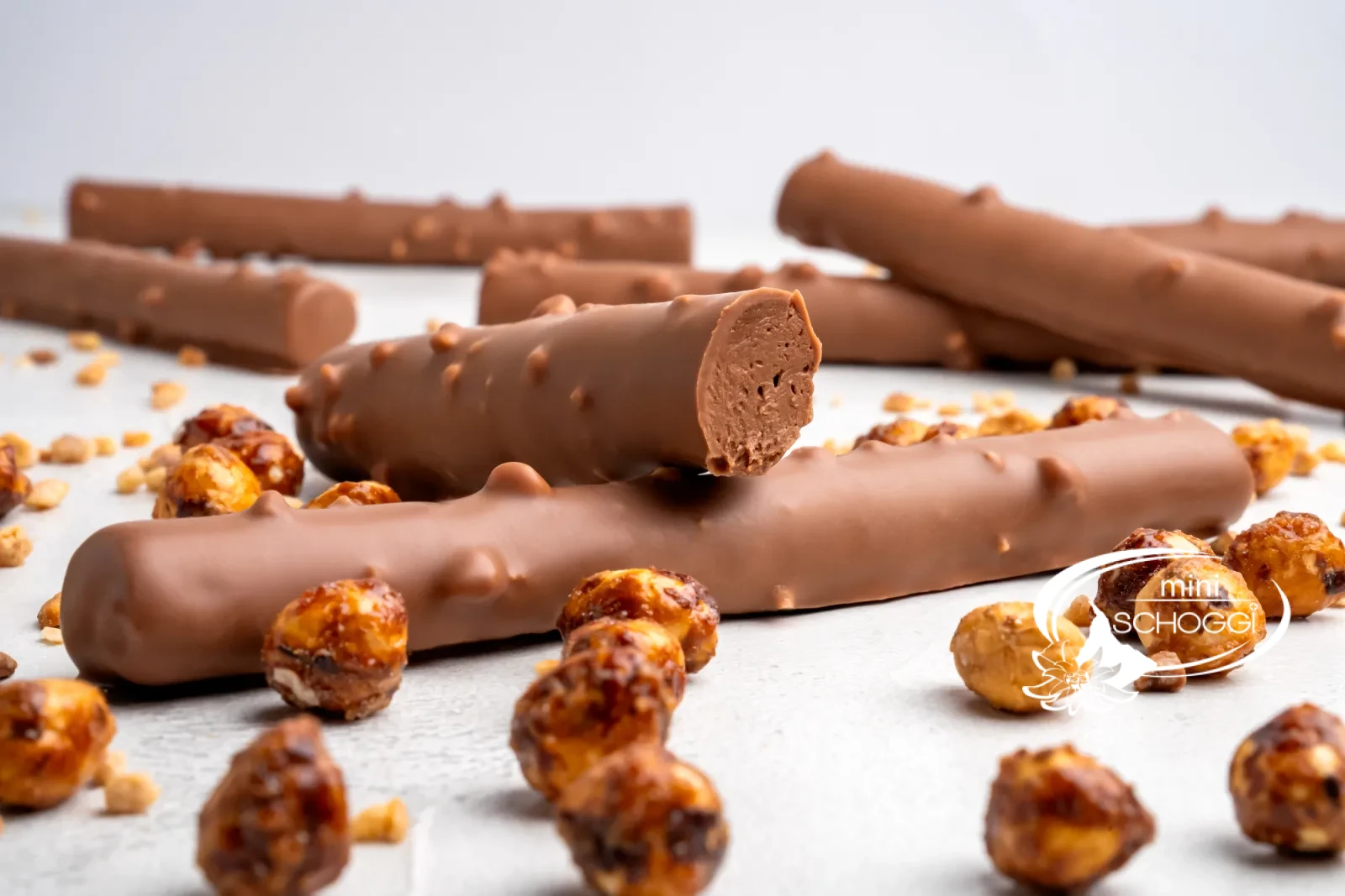 Homemade chocolate twigs with Hazelnut brittle next to caramelised hazelnuts
