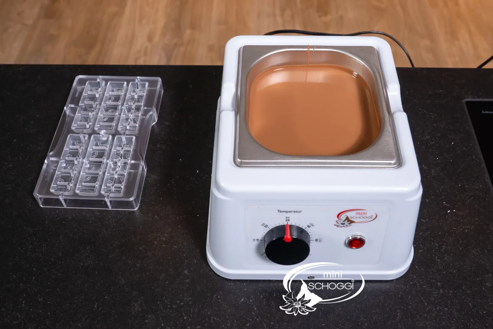 The Milk couverture is brought to working temperature in the tempering device