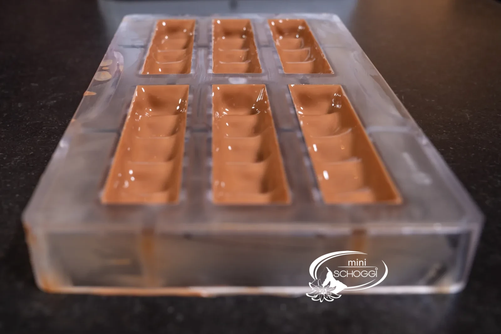 The neatly poured mold with an even chocolate shell