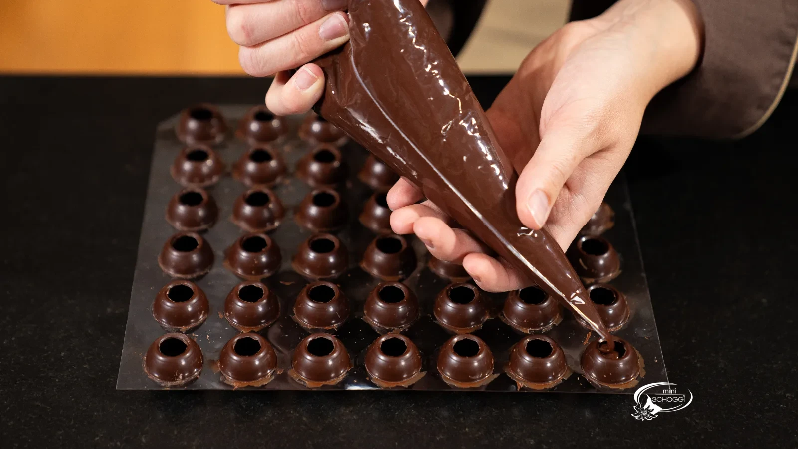 Les boules de praliné creuses sont garnies avec la Ganache
